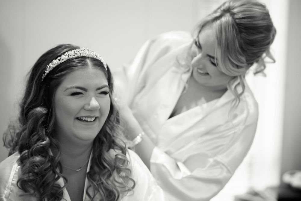 A heartwarming black and white moment captured during wedding day preparations.