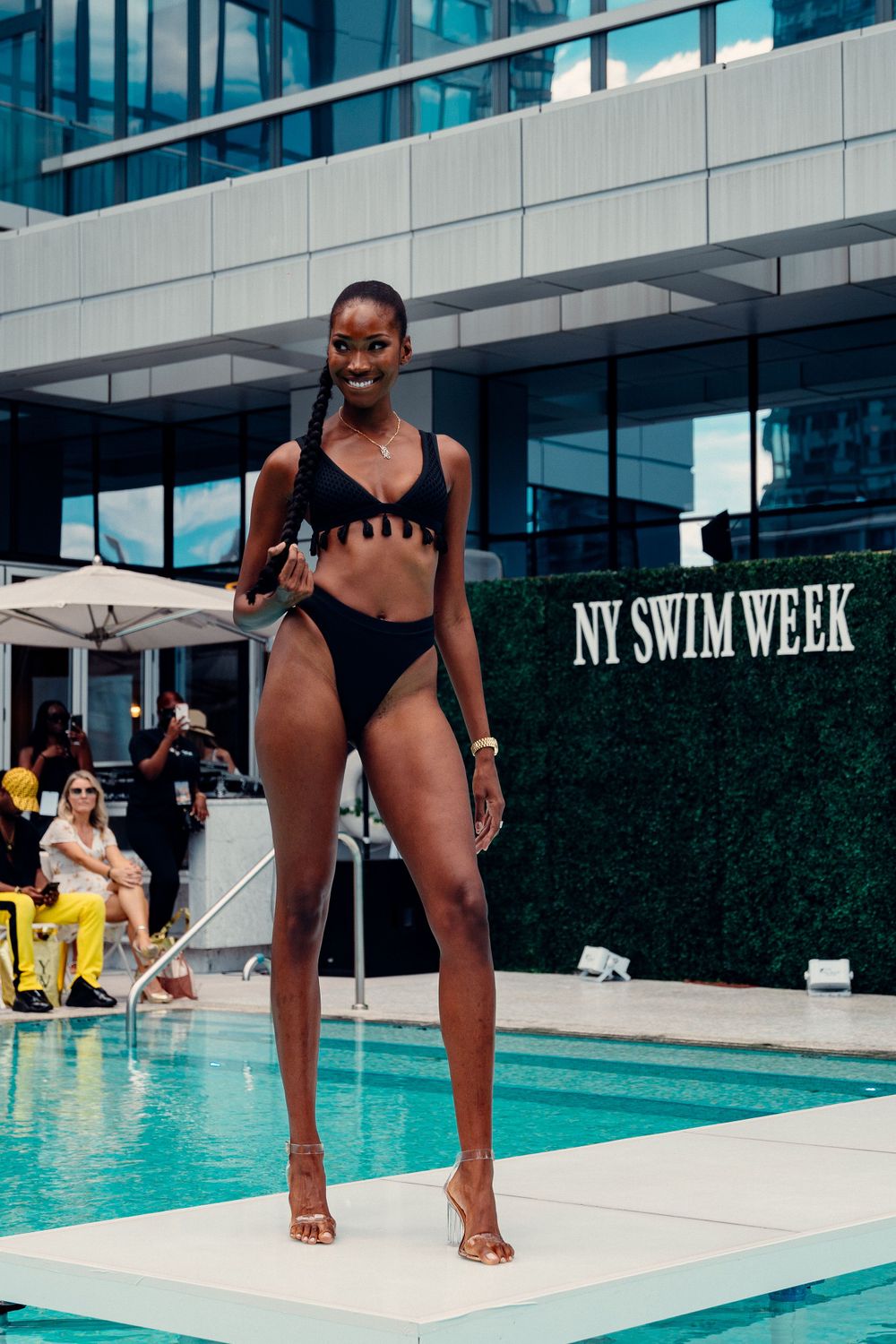 Models walk the runway in swimwear at NY Swim Week poolside fashion show.