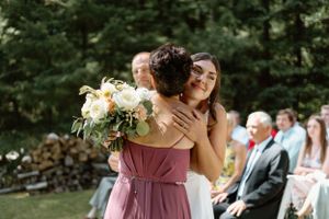 Bride hugging her mother before getting married during a cottage wedding in Muskoka