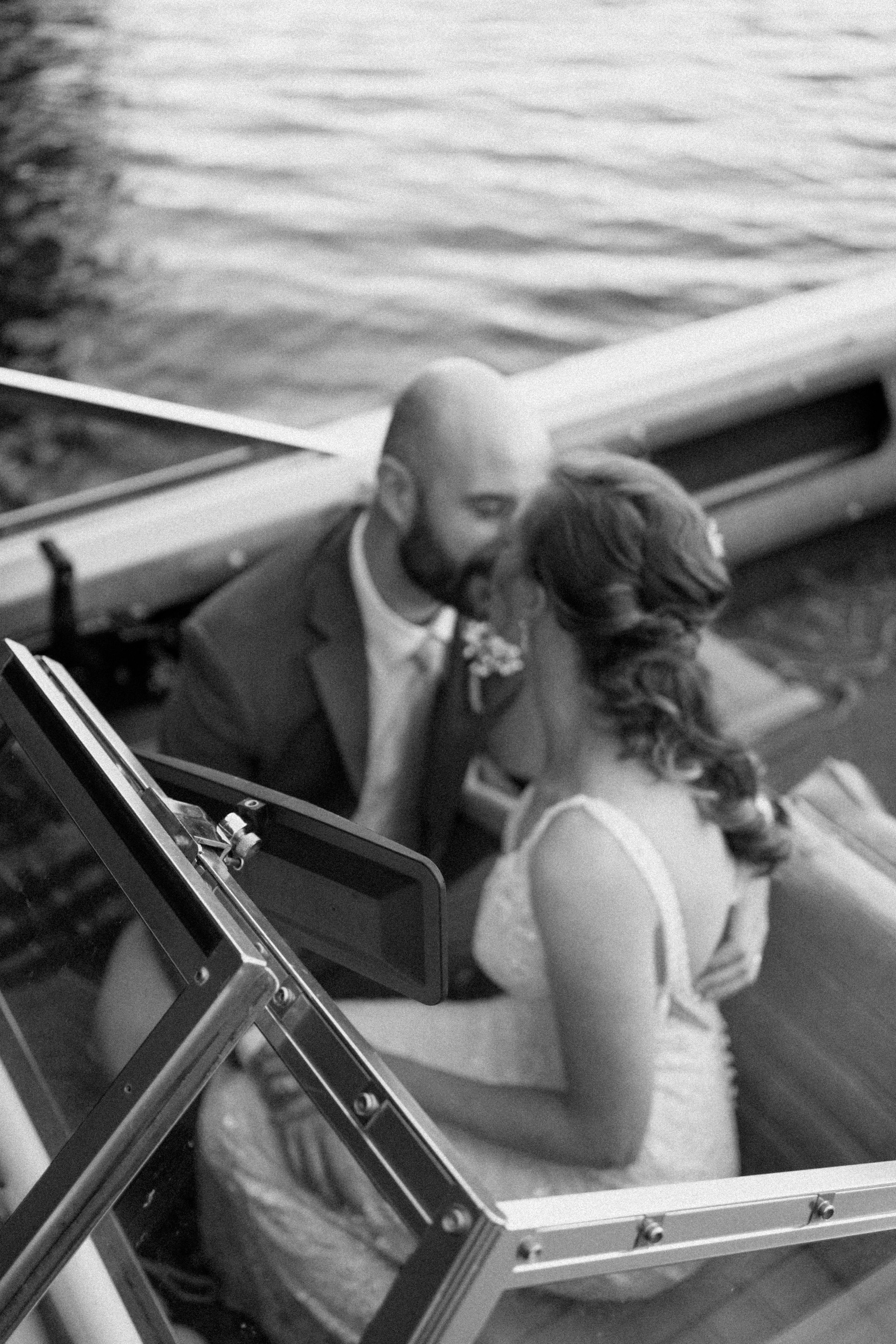 Bride and groom kissing in a boat on Lake Waseosain Muskoka taken by Alexis Anne Photography