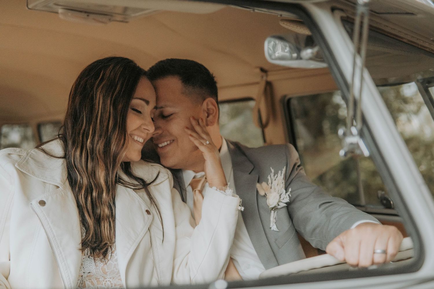 Intimate moment captured in vintage car interior with soft natural lighting.