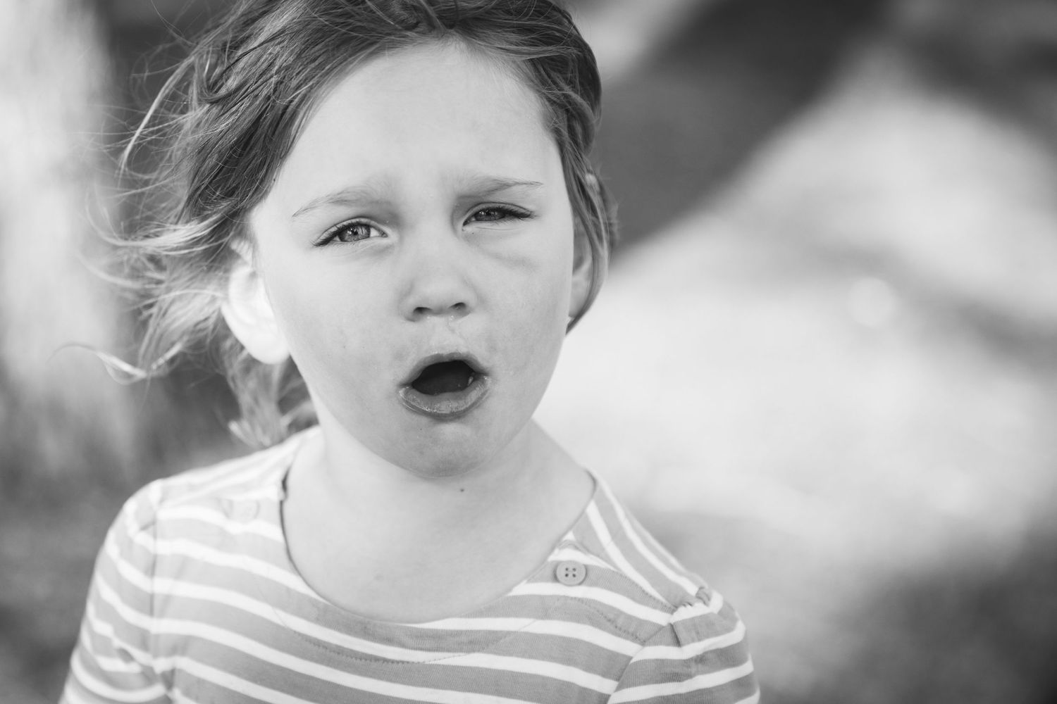 Black and white portrait showing expression of wonder and excitement.