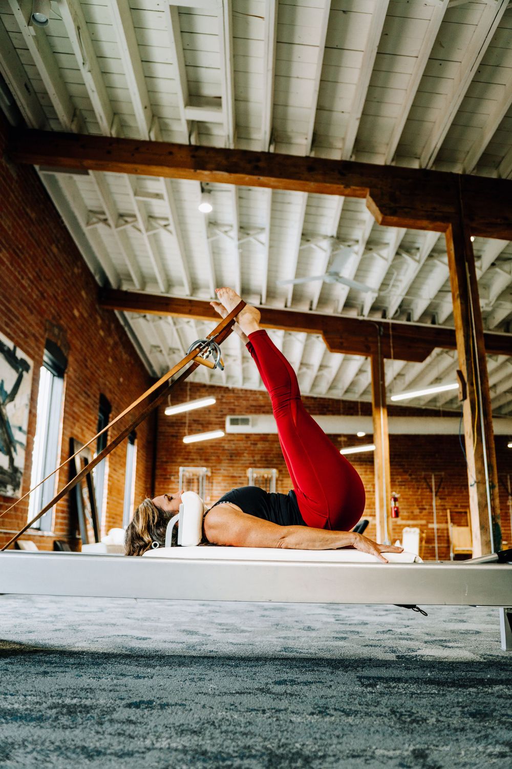 Dynamic low-angle shots of person jumping against industrial ceiling.