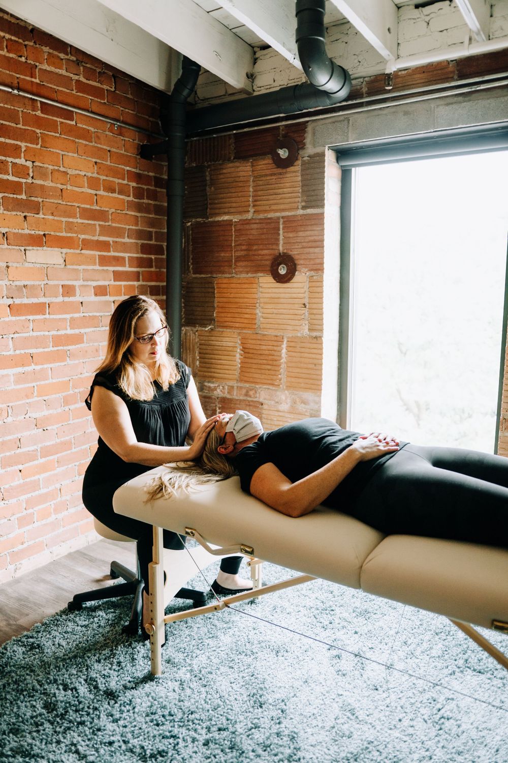 Athletic movement sequence captured in industrial brick and window setting.