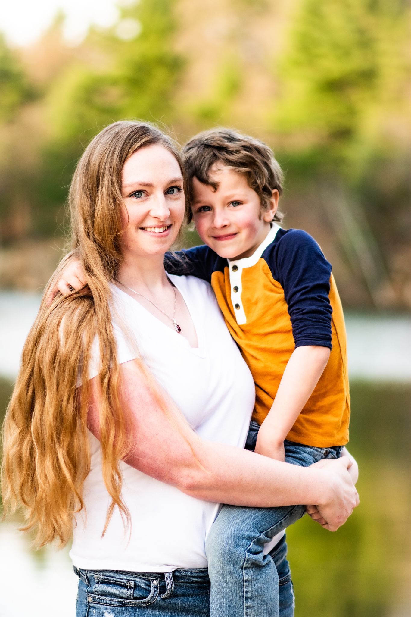 A heartwarming outdoor portrait of a parent and child against a natural backdrop.