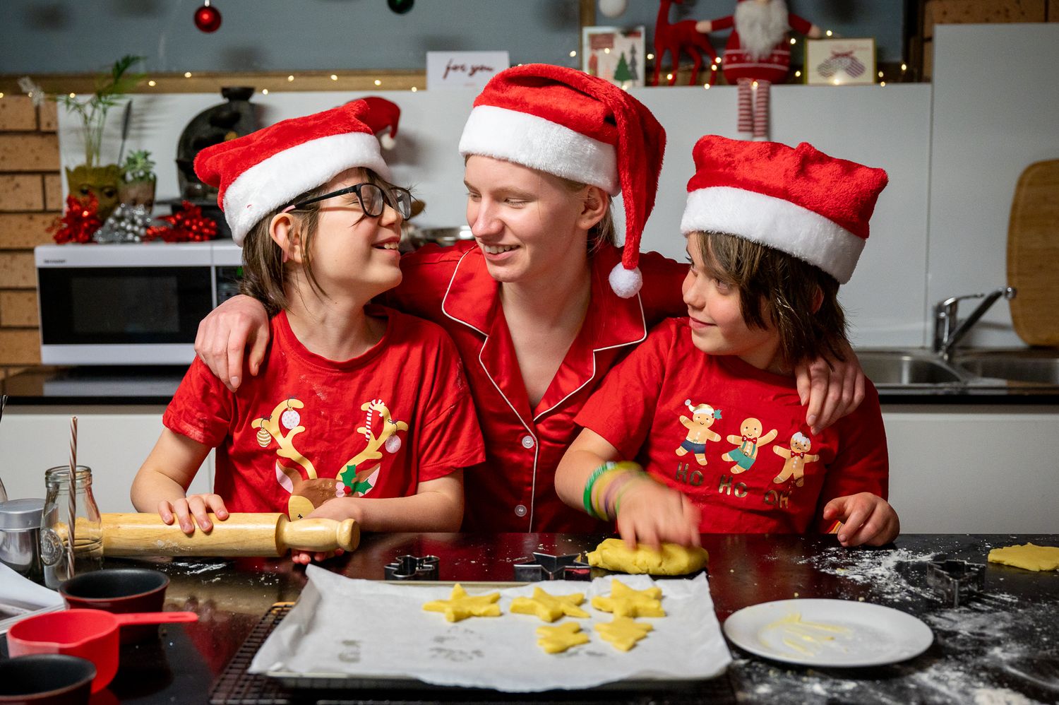 Three siblings enjoying Christmas cooking