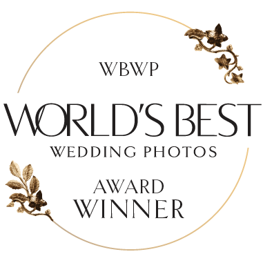 World's Best Wedding Photos award winner logo with golden floral design elements.