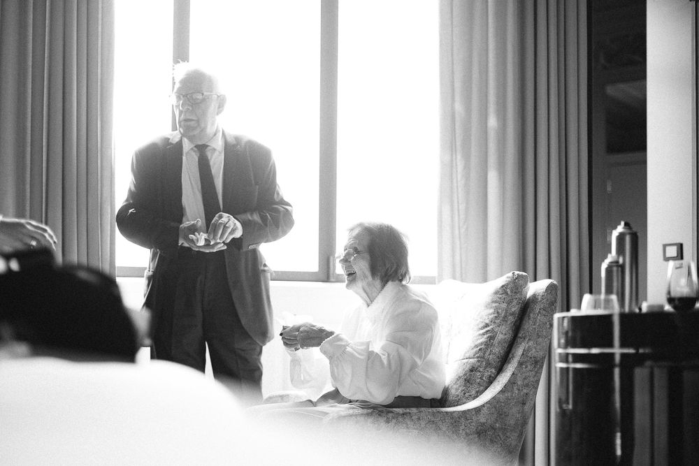 Black and white photo showing morning light streaming through hotel room window.