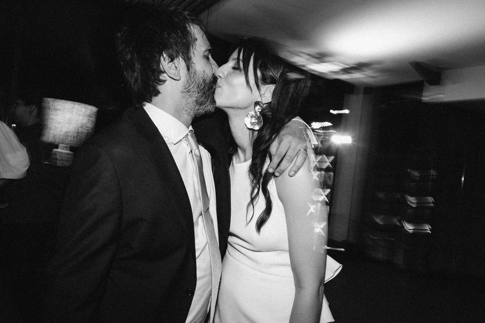 A romantic black and white moment shared between a couple at their wedding celebration.