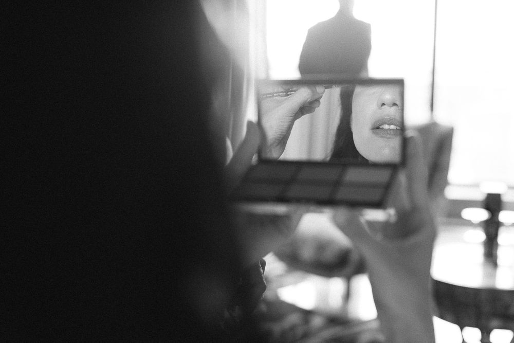 Blurry black and white photo showing a laptop screen in low light.