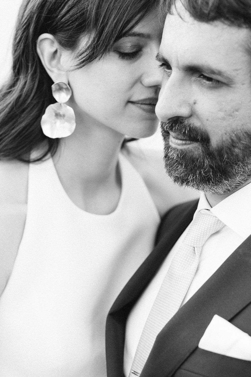 A tender black and white close-up of a couple in an intimate moment.