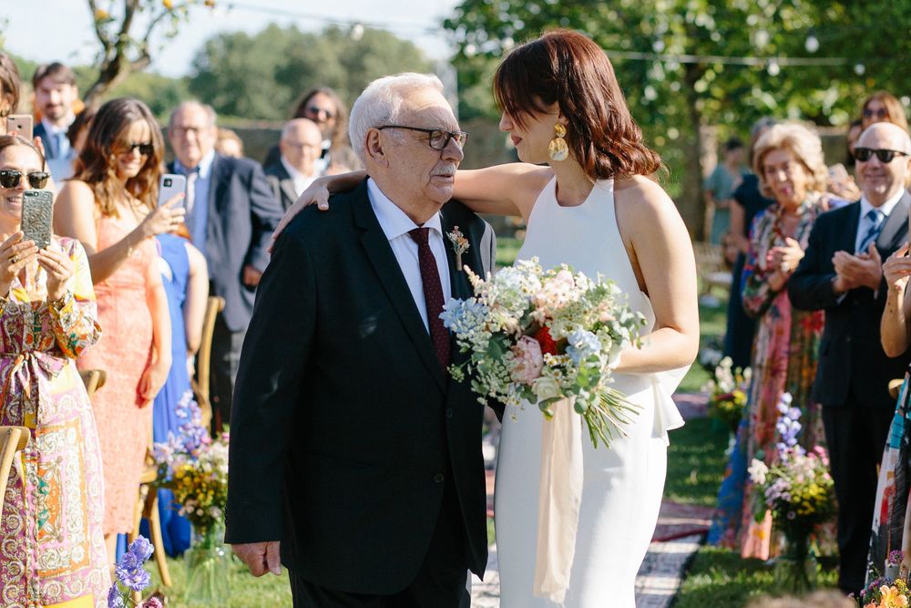 An emotional moment captured during an outdoor garden wedding ceremony.