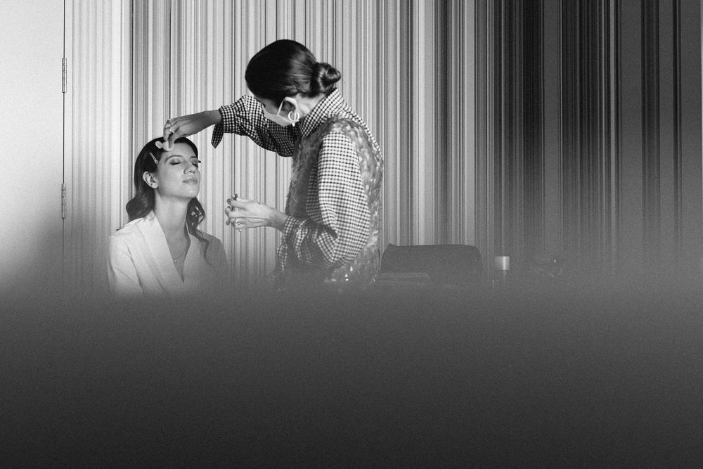 Black and white image of wedding preparation moment.