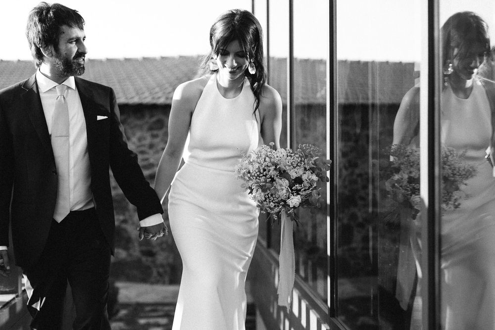 Black and white wedding portrait showing a couple with a bouquet.