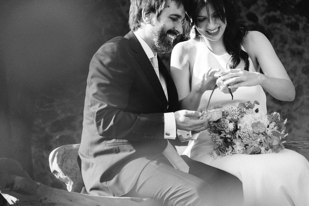 A black and white candid moment of celebration during a wedding.