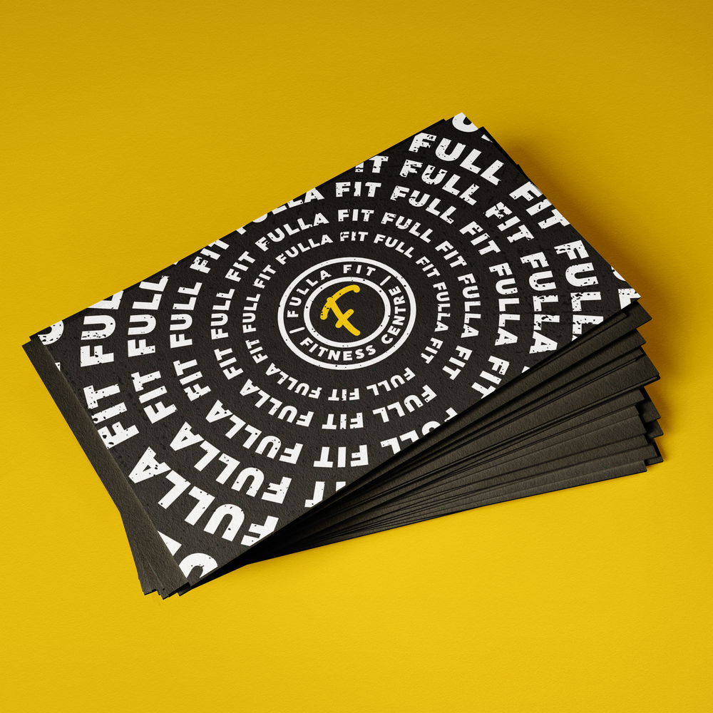 Stack of black and white Fulla Fit Fitness Co. business cards on yellow background.
