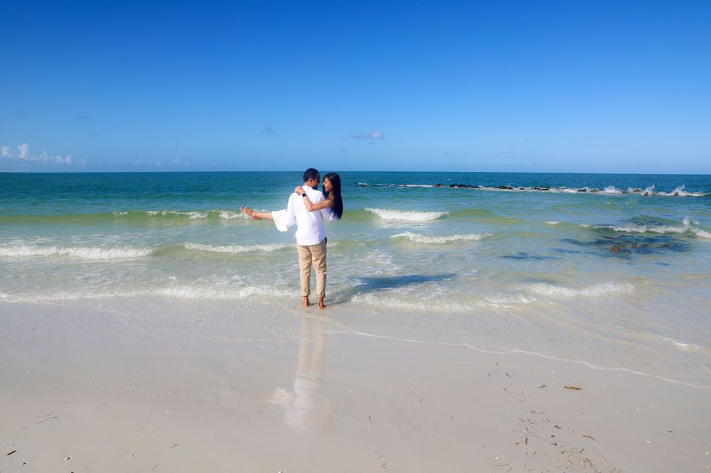 Engagement Photography – Romantic Coastal Embrace in Crystal Blues

This tender engagement portrait captures a serene and heartfelt moment