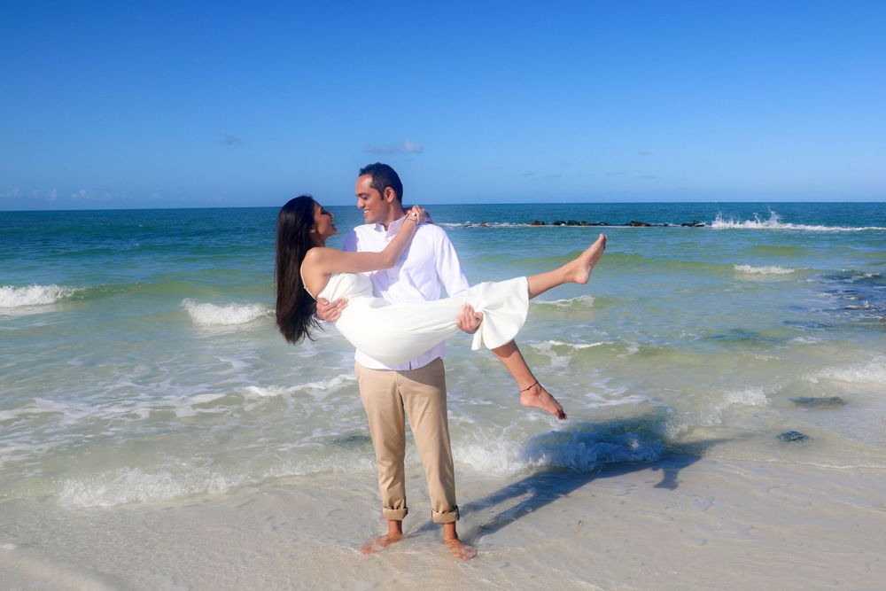 Engagement Photography – This cheerful beach engagement portrait captures a carefree moment
