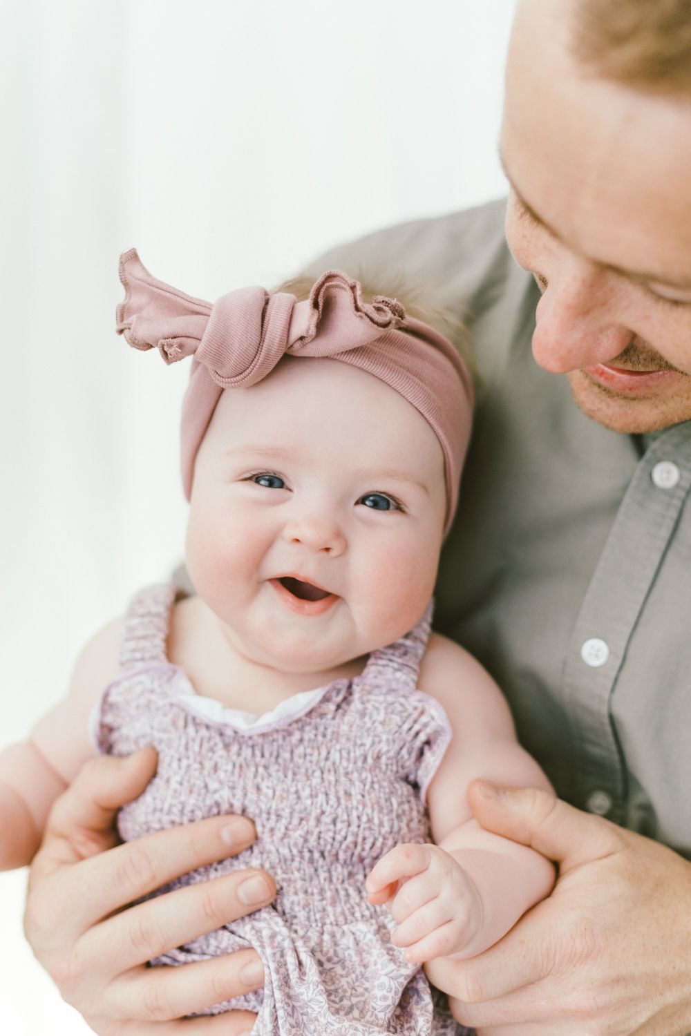 Sweet moment captured in portrait session against white background.