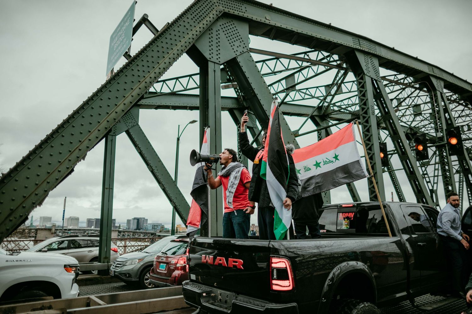 Palestinian activist uses mega phone to lead crowd in chants on Hawthorne Bridge Portland, Oregon photojournalism