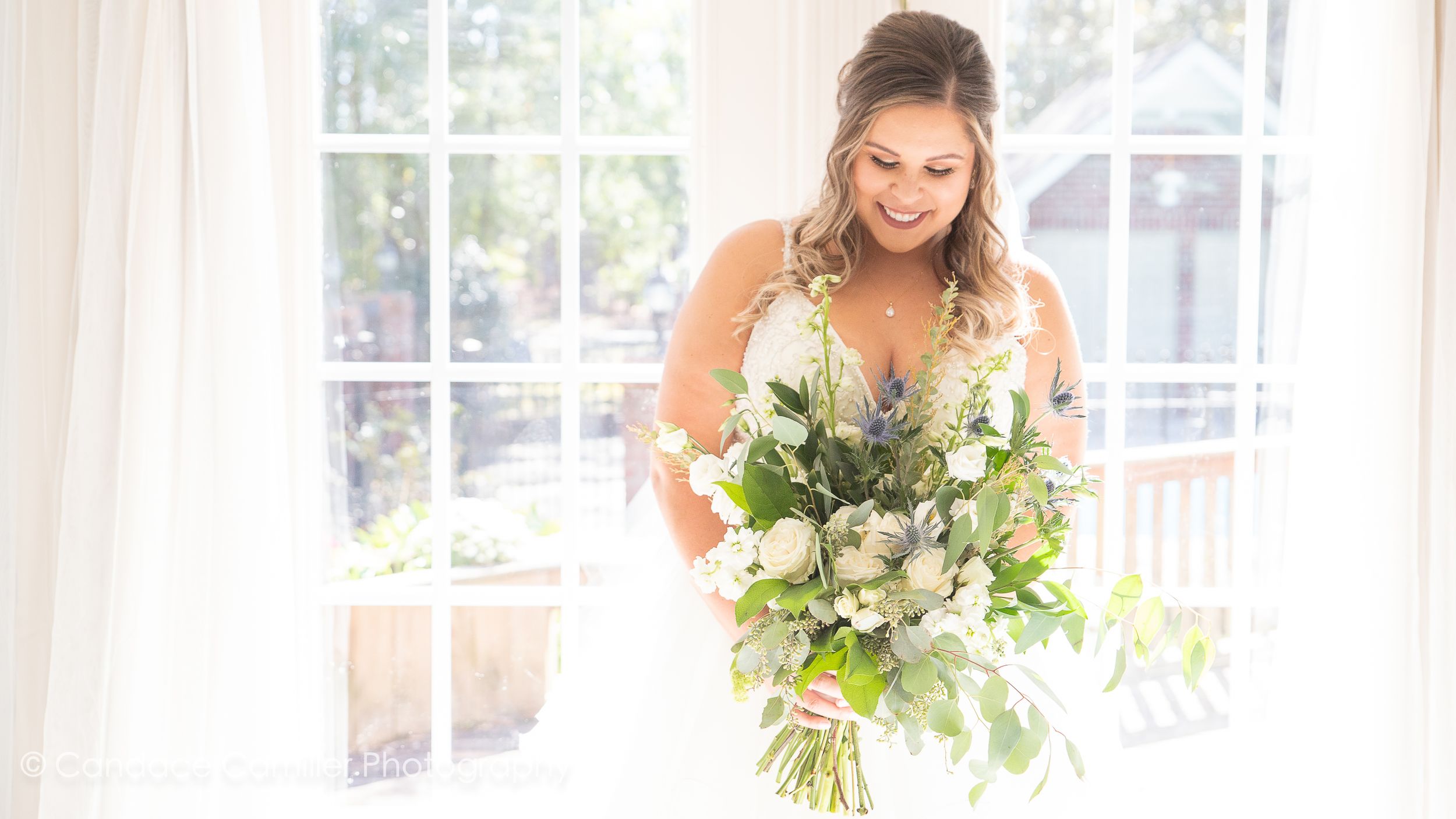 A radiant bride holding her bridal bouquet, a symbol of beauty and love on her special wedding day.