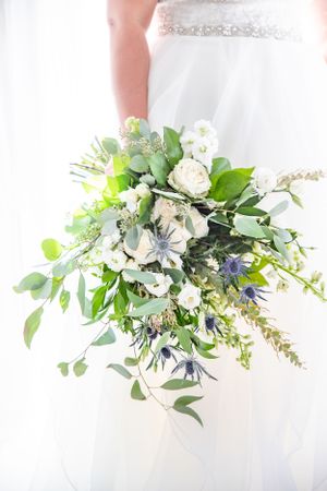 The bride's bouquet, a stunning arrangement of flowers, representing beauty and love, ready to accompany her down the ai
