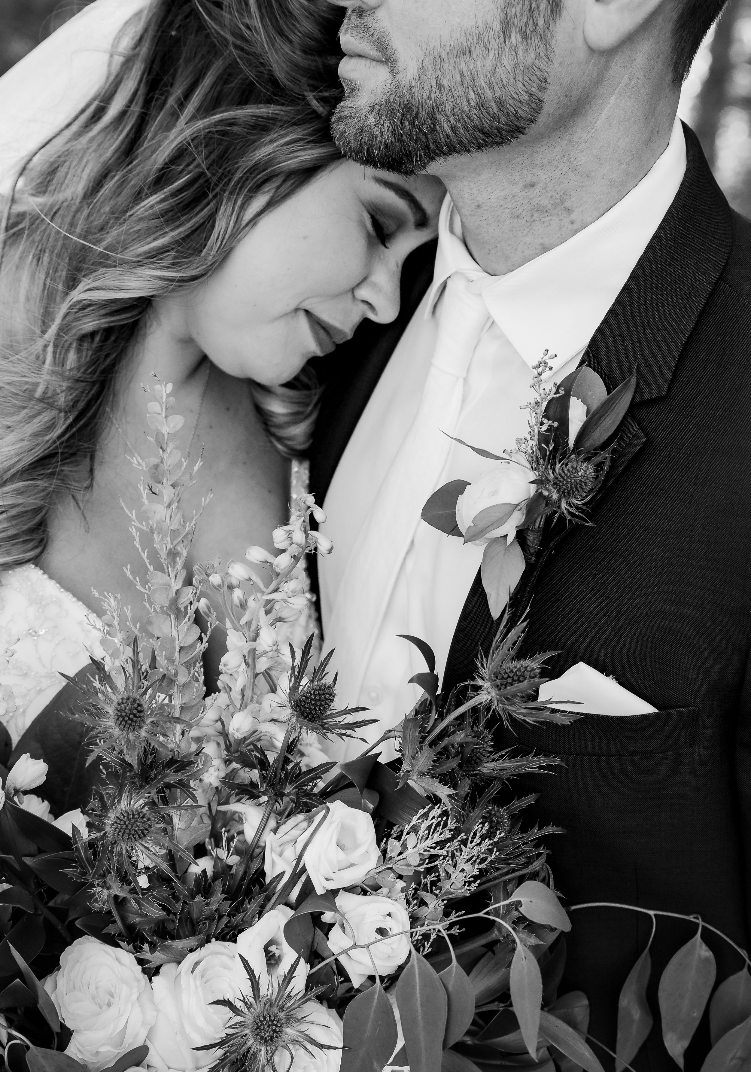 A tender and serious moment: the bride being held in the groom's arms, capturing their profound love and commitment.