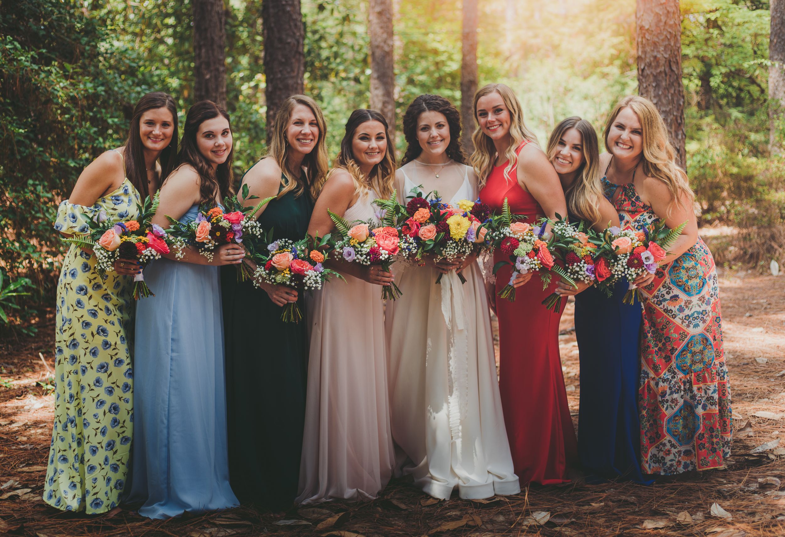 Bridesmaids in the midst of a forest, sharing a special moment amidst the serenity of nature, radiating support and unit
