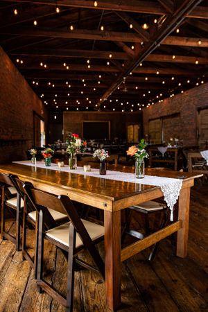 A rustic table setting, featuring earthy elements, wooden decor, and wildflower centerpieces, creating a charming and co