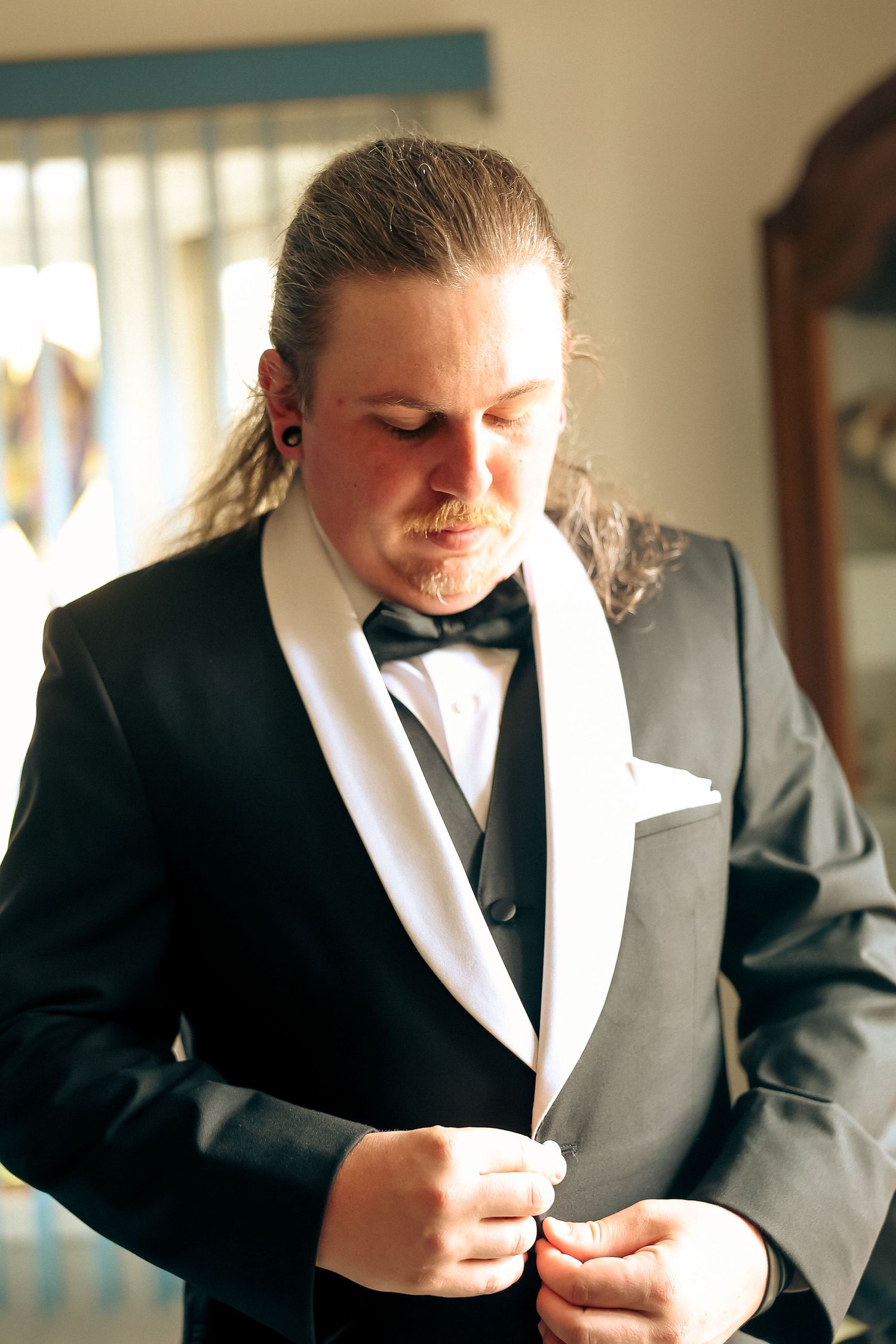 Wedding preparation scene showing person in formal attire reading a letter.
