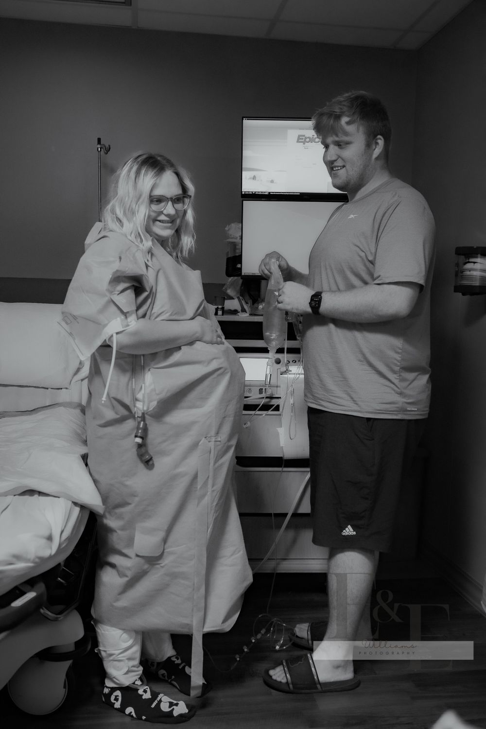 Healthcare providers in a dimly lit medical room performing patient care.