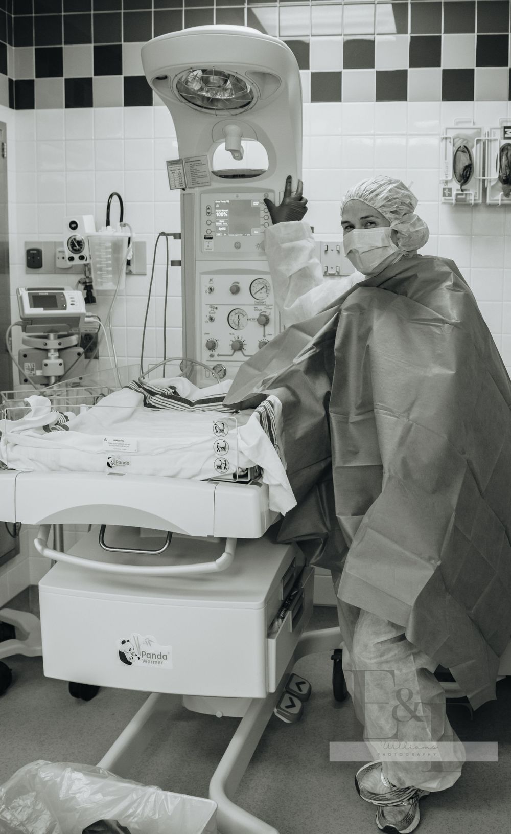 Medical staff working with equipment in a hospital operating room.