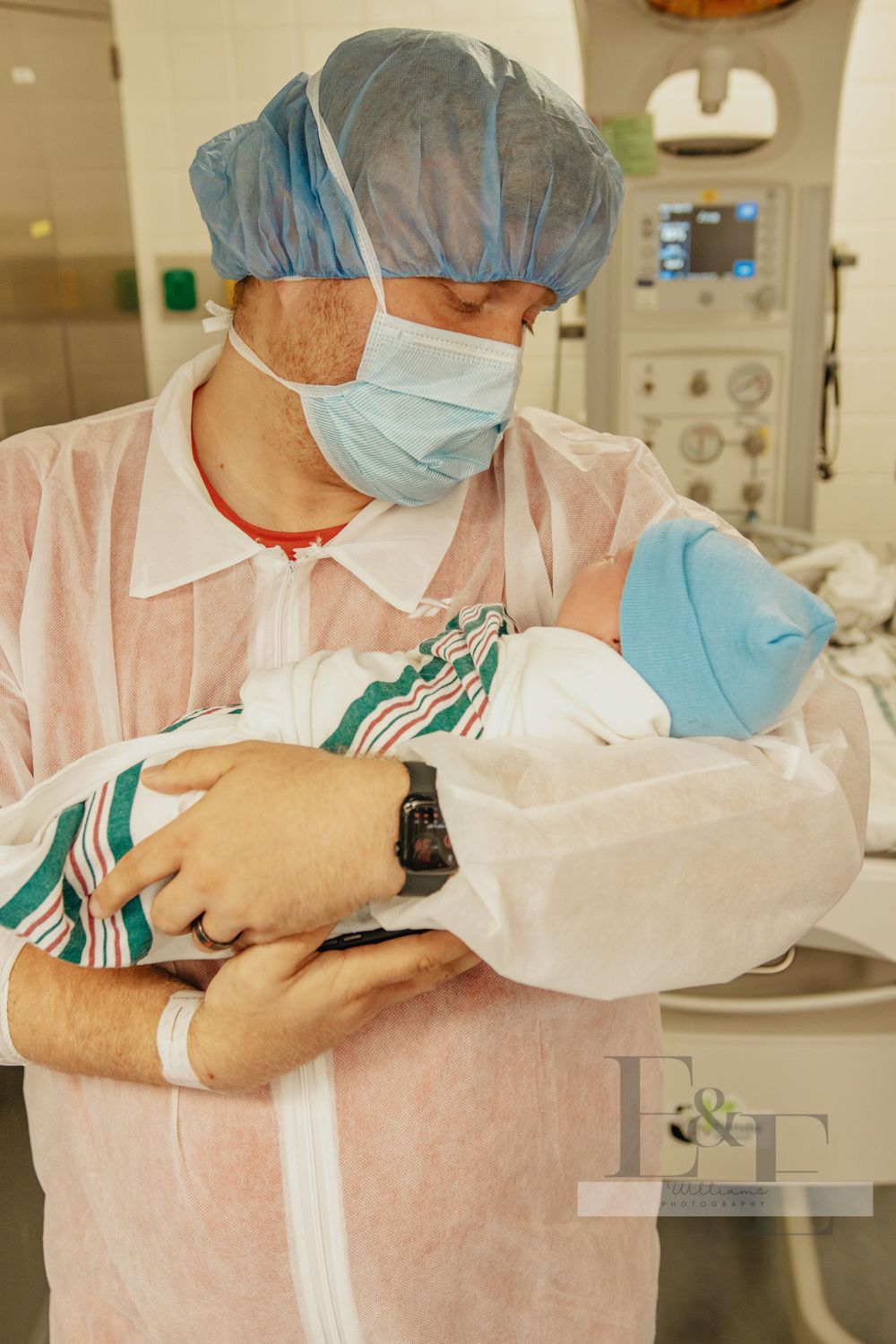 Healthcare workers in protective gear and masks performing medical procedures.