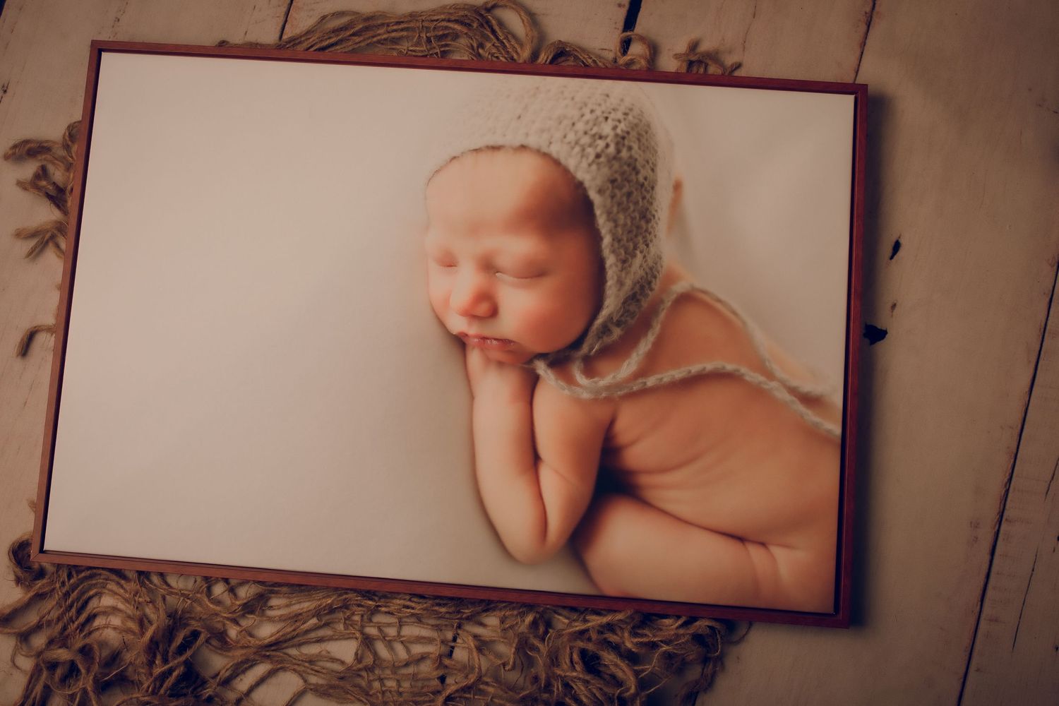 Professional newborn photography studio setup with neutral props and soft lighting.