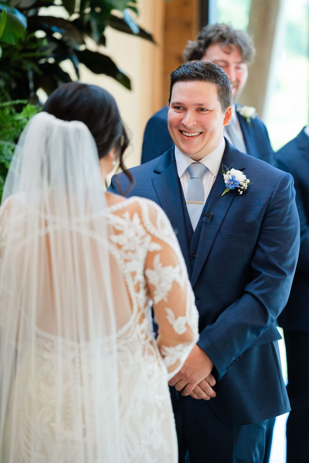 Groom smiles at bride during wedding at Jorgensen Farms in Westerville, Ohio.