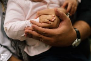 Close-up of hands gently holding together in tender moment.