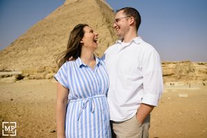 Couple shares a joyful moment together in front of the Great Pyramid of Giza.