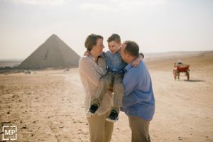 Family shares an intimate moment together in front of the iconic Egyptian pyramids.