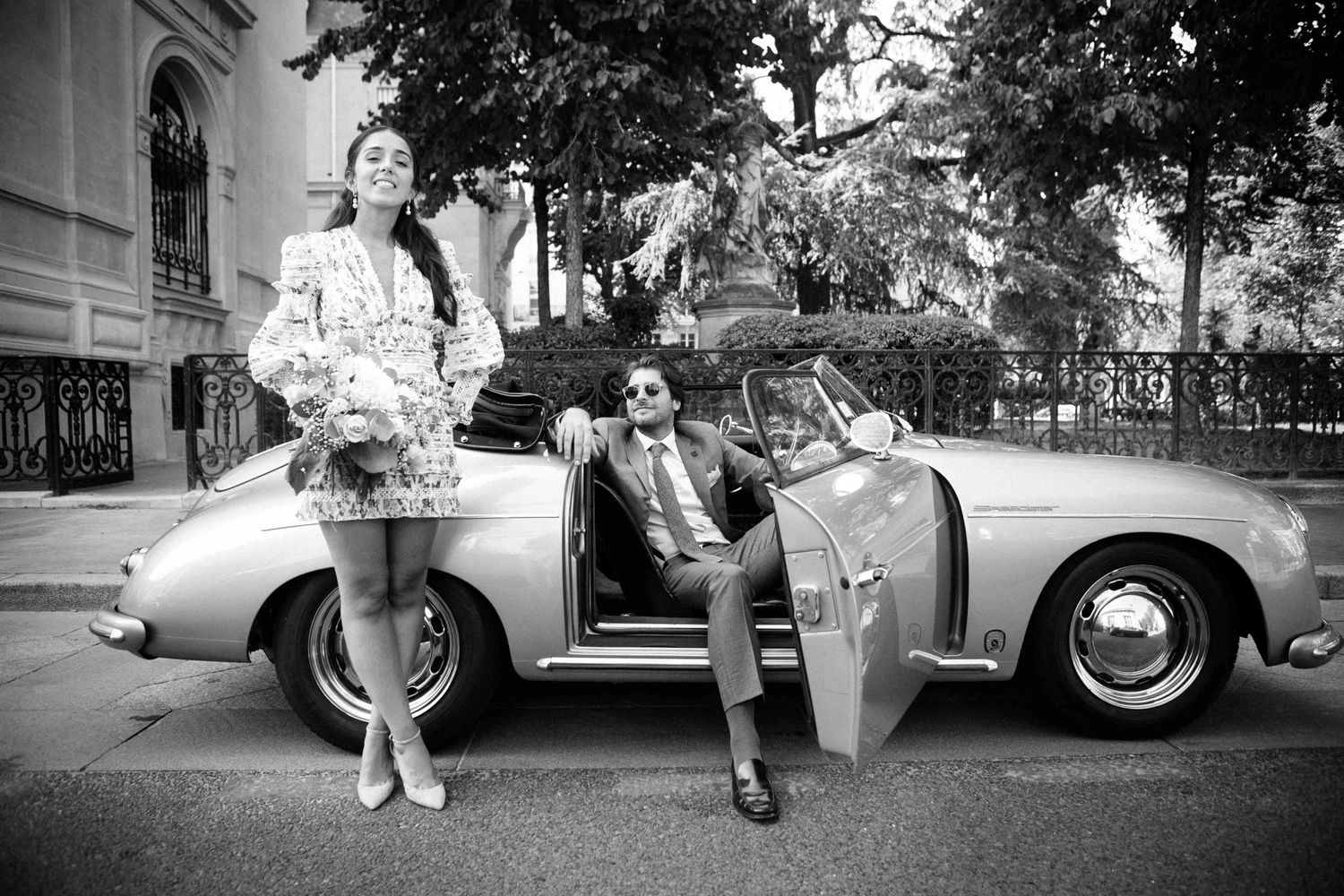 Classic vintage car parked on a street with retro style black and white photography.