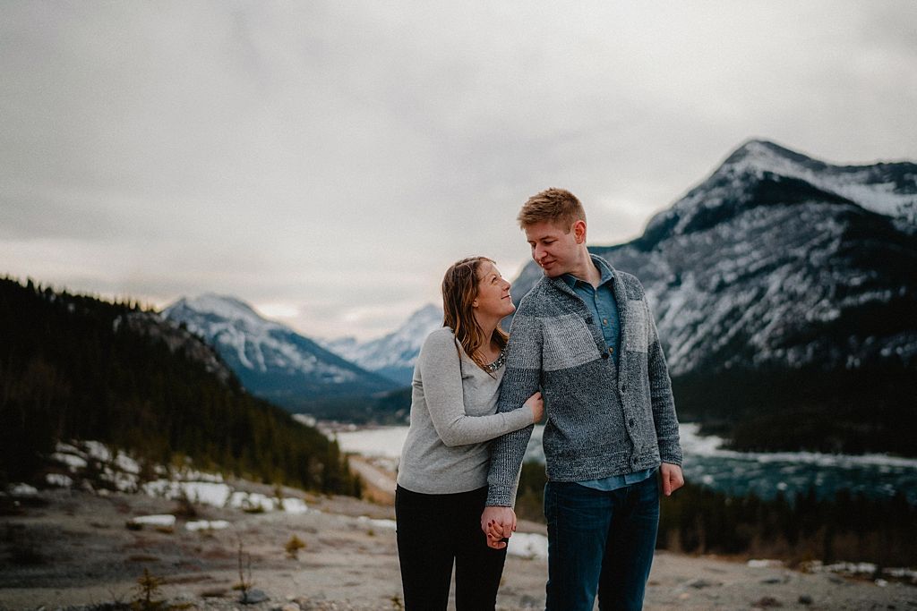 A romantic stroll along a snowy mountain path with dramatic peaks in the distance.