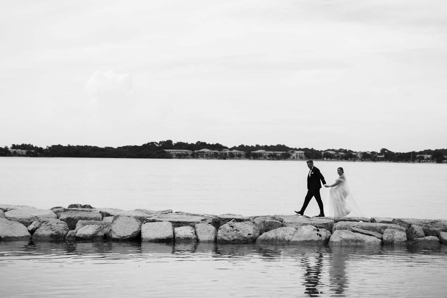 Bride and groom walking by the sea in Jamaica