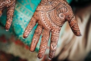 Close up of Indian bride's hand with henna design during mehndi party in Redondo Beach, California