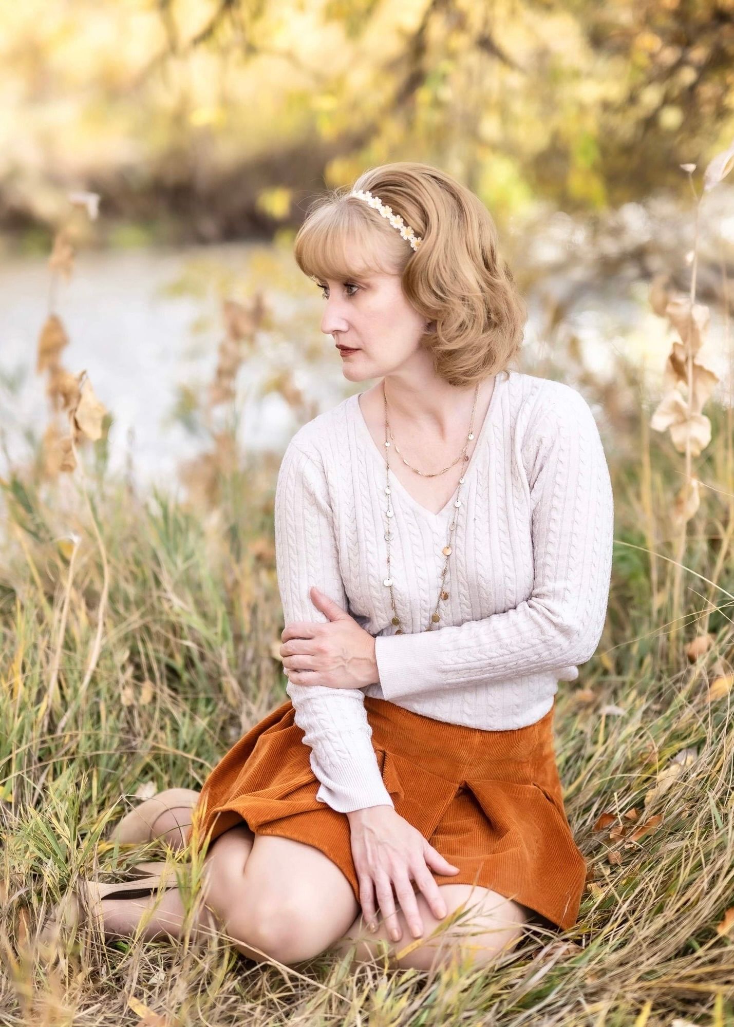 Vintage style portrait of Mon Ami Mindy in a field with cream sweater and rust colored skirt.