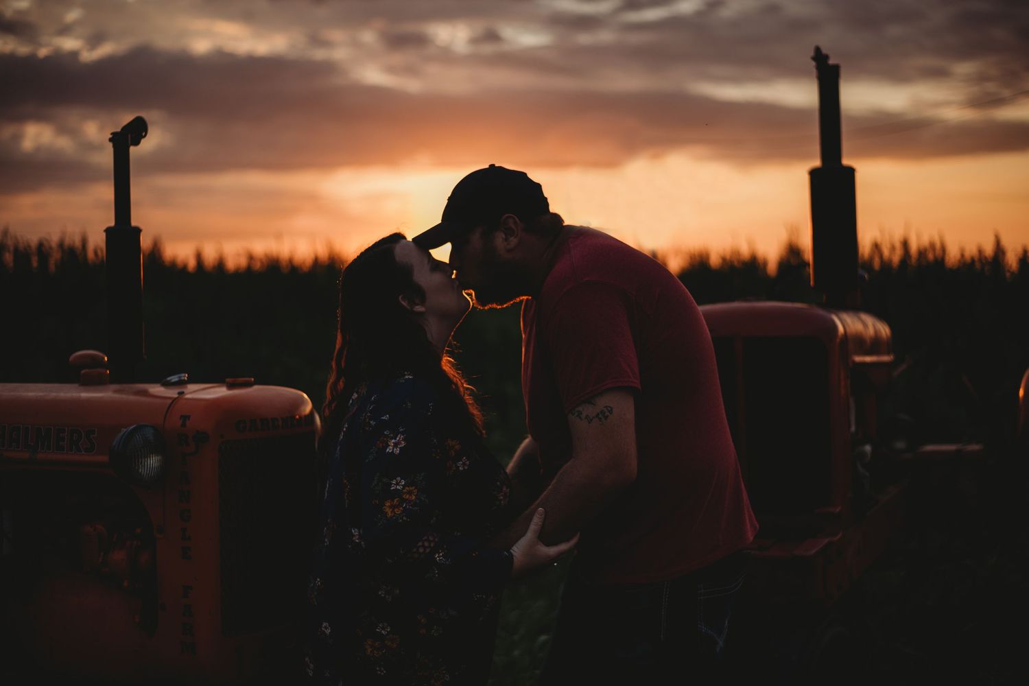 tractor engaged couple during sunset