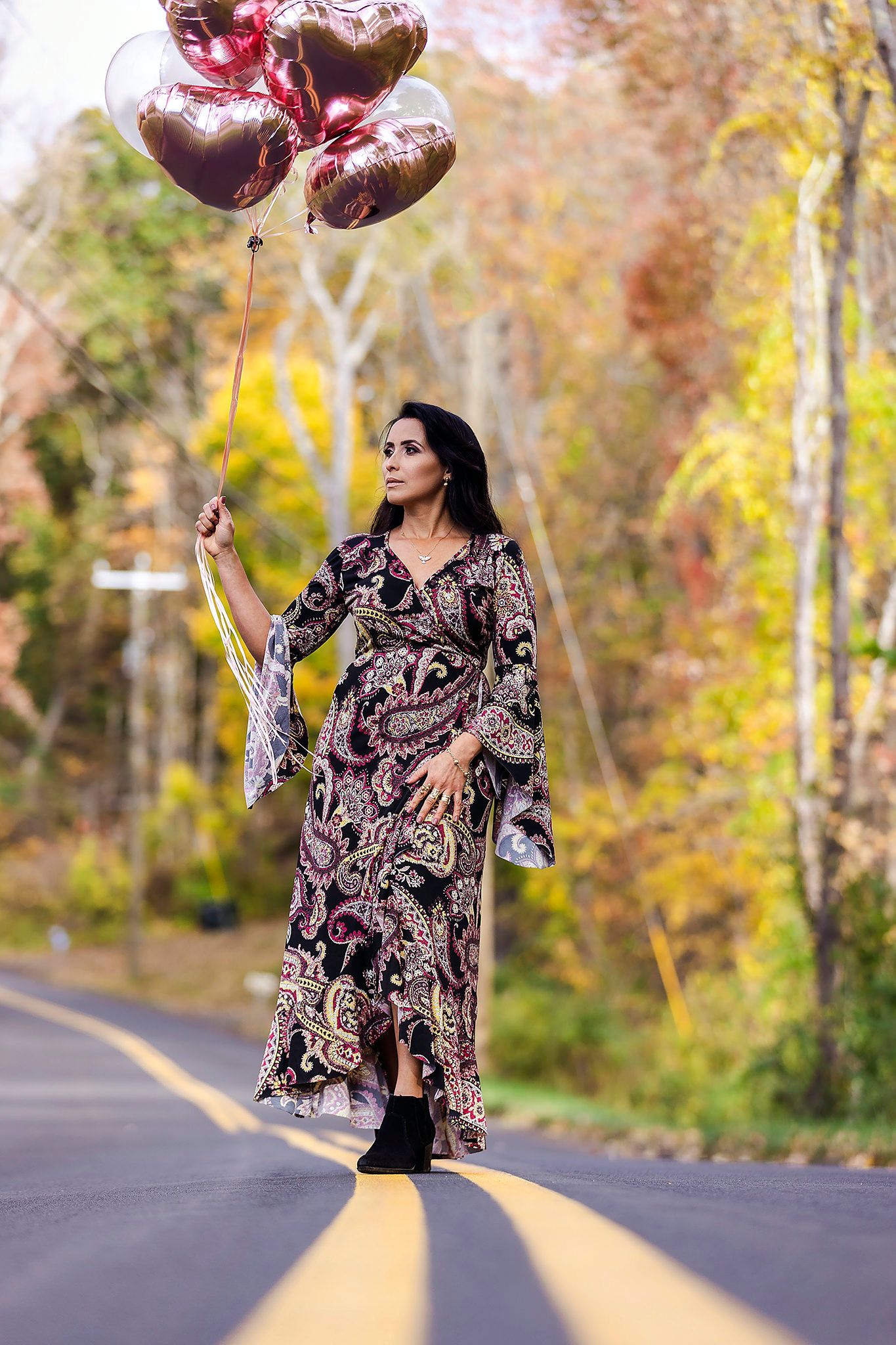 Dynamic fashion sequence on autumn road with paisley dress and flowing movements.