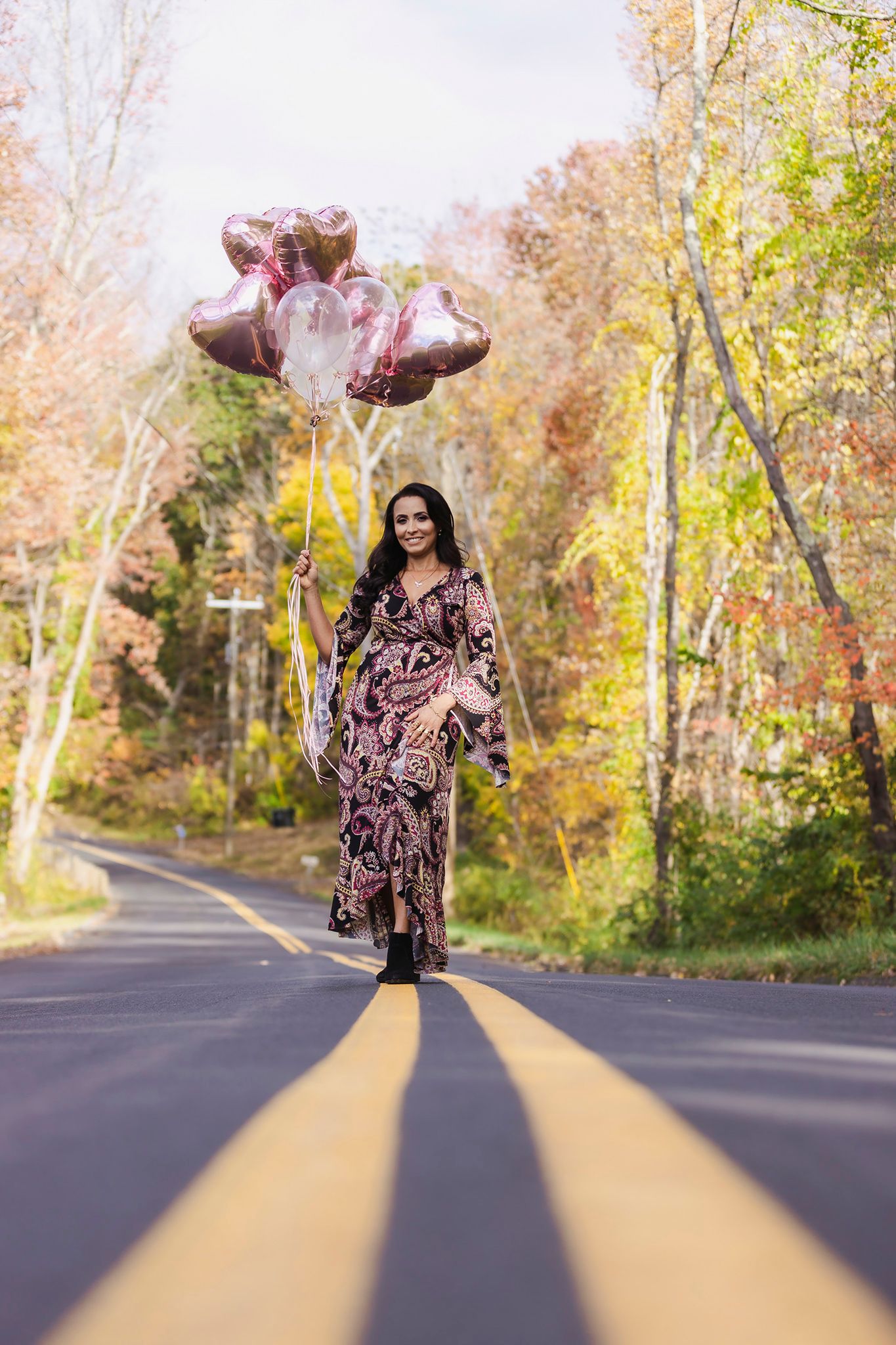 Creative autumn road photoshoot with flowing dress and dynamic movement sequences.
