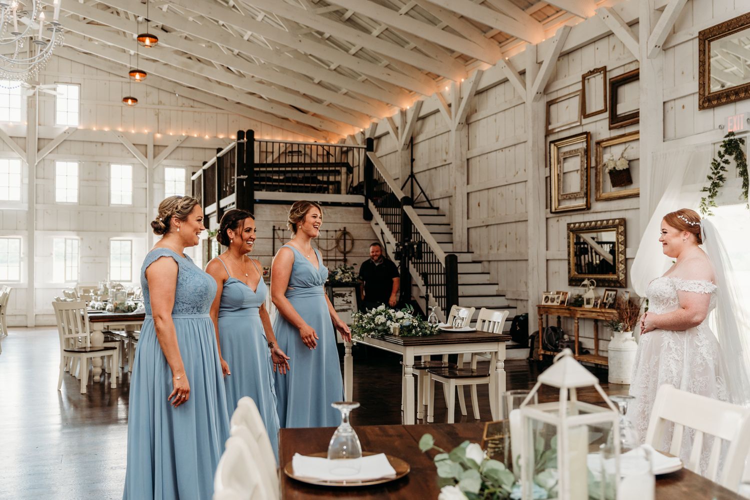 Bride shares a first look with her bridesmaids at The White Barn at Lucas Farms in Oakland, MD