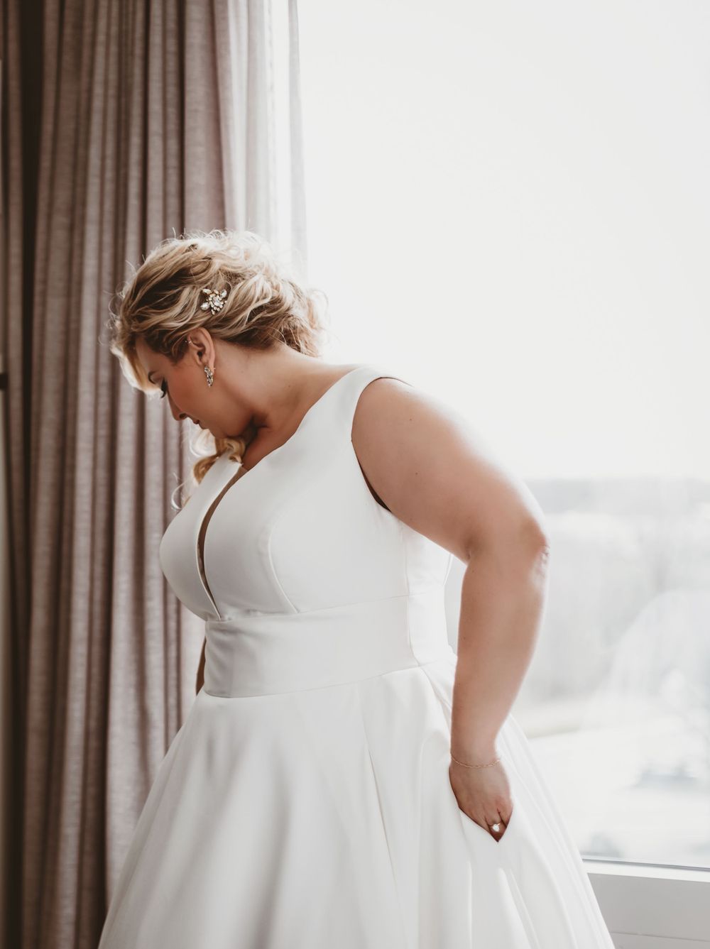 White wedding dress on model showing elegant back detail.