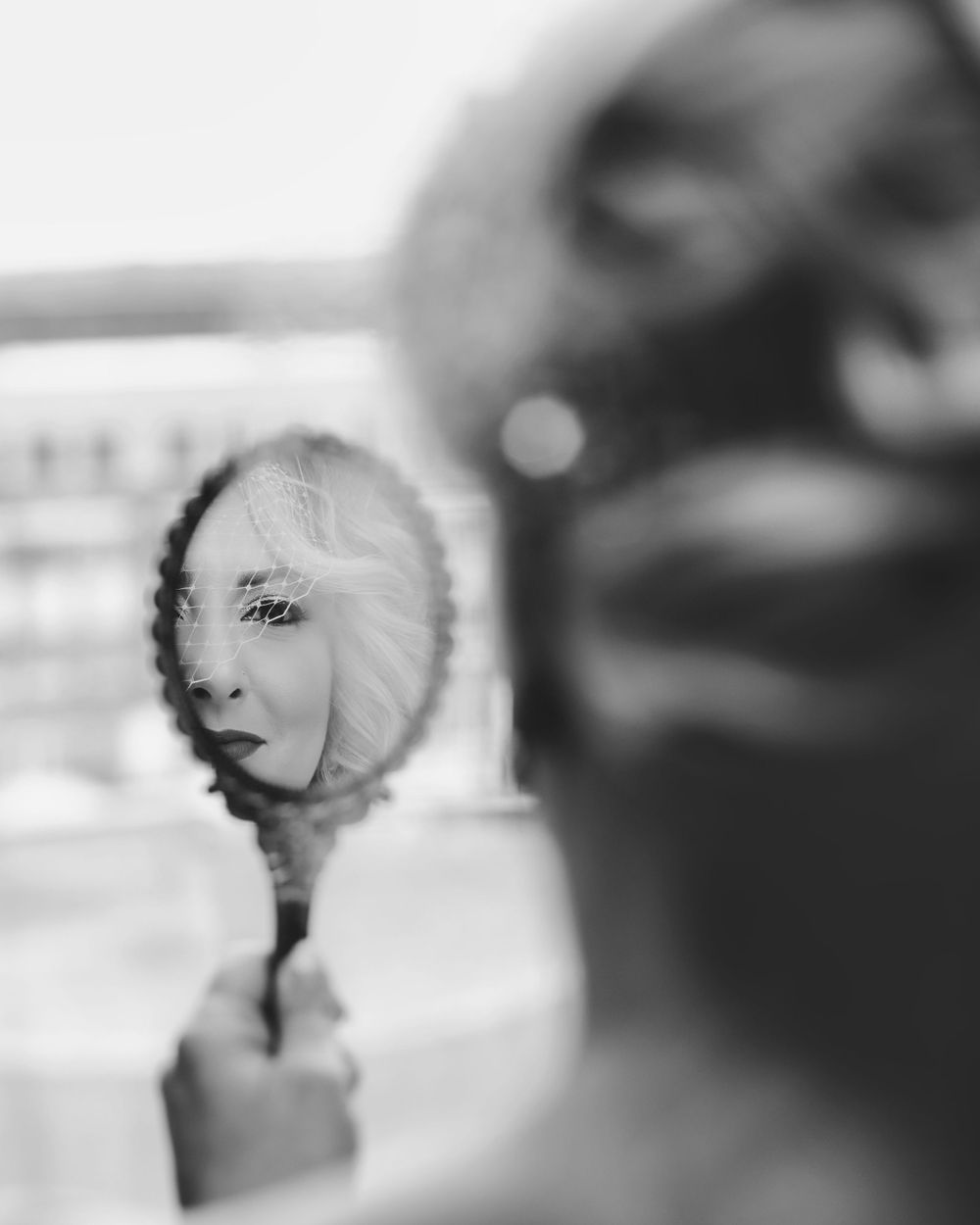Artistic black and white wedding portraits with soft focus effect.