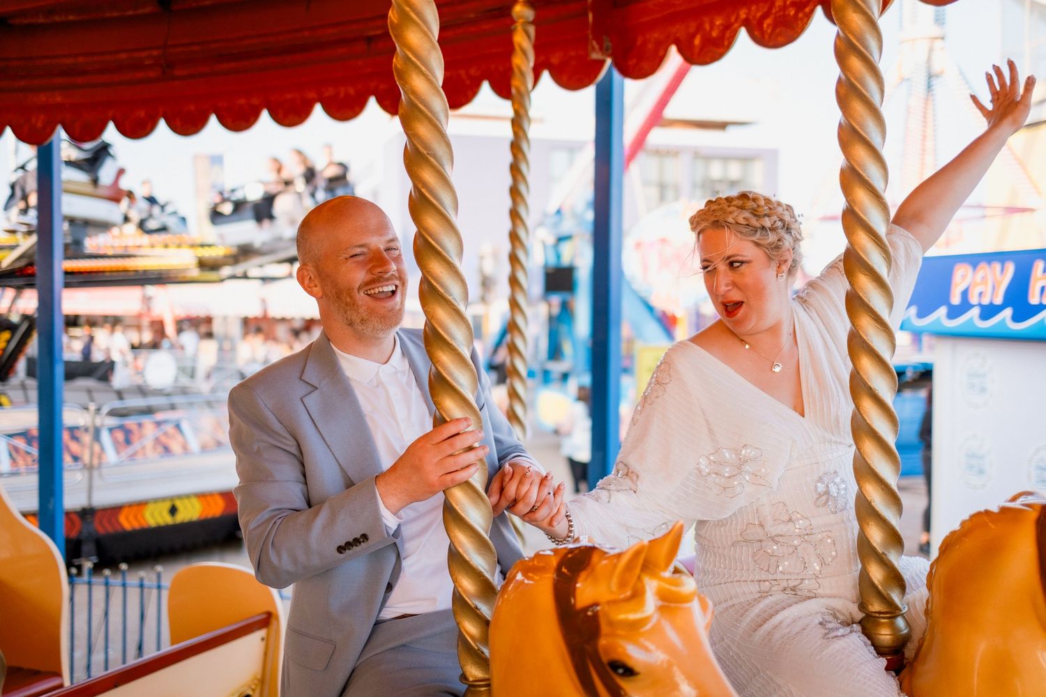 bride and groom riding merry go round alternative couple photos